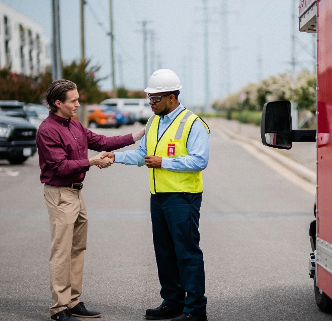 Rainbow Restoration technician shaking the hand of a customer.