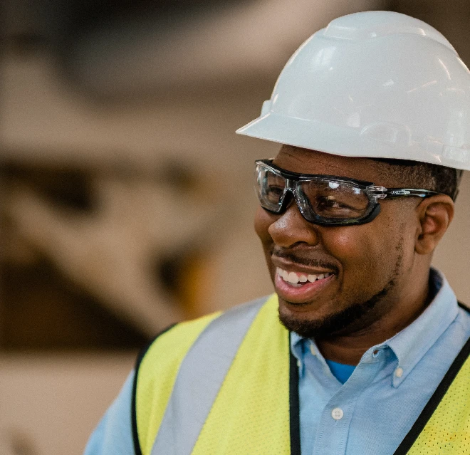 Smiling Rainbow Restoration technician with hardhat.