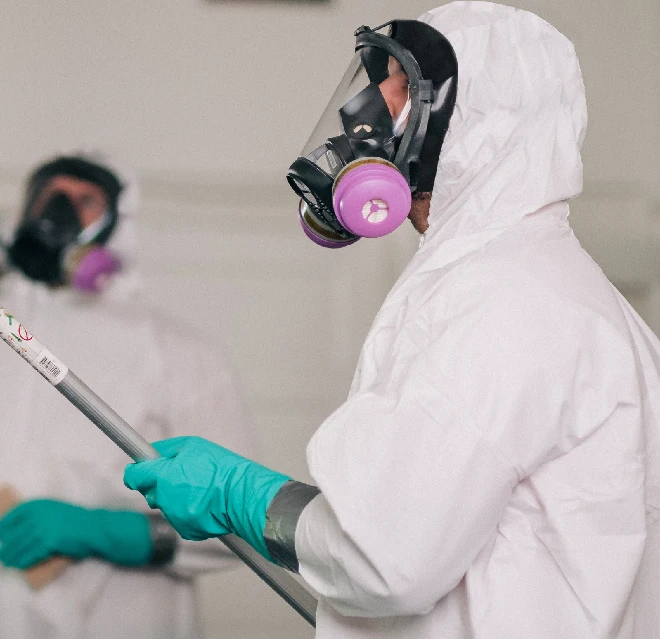 Rainbow Restoration associate in white hazmat suit.