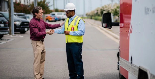 Rainbow Restoration technician shaking the hand of a business owner.