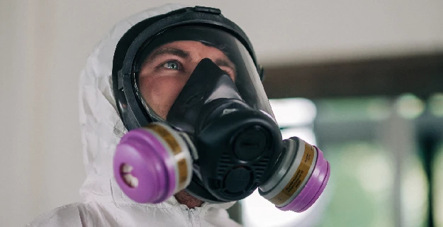 Rainbow Restoration technician wearing a hazmat suit.