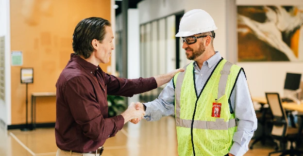 Rainbow Restoration technician shaking the hand of a business customer.