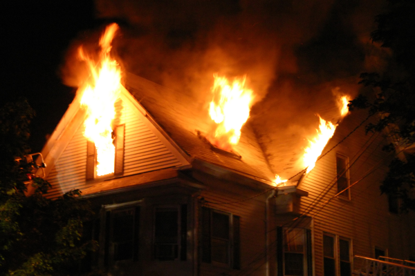 Home that has flames coming out of windows.