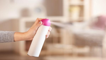 Person spraying air freshener