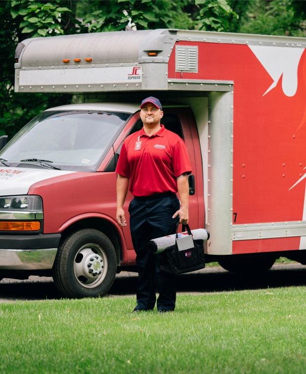 Rainbow Restoration technician approaching a vehicle.